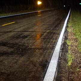 Reflective road markings under wet pavement and inclement weather conditions.