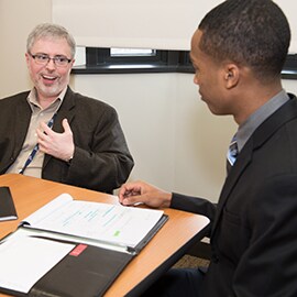 3Mer John Sebastian with a student at the University of Toledo Invitational Sales Competition.