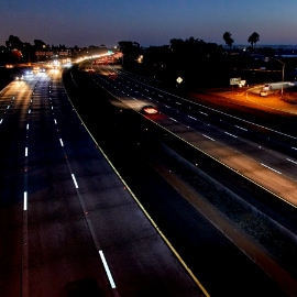 Image of 8 lanes of traffic at night with white 3M™ Stamark™ All Weather Tape Series 380AW visible.