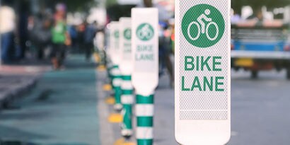 Row of bike lane signs identifying protected bike lane.
