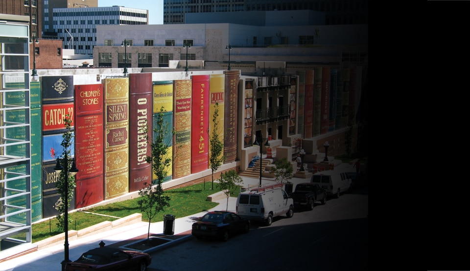 Outside of the Kansas City Central Library parking lot, wrapped in 3M Controltac Graphic Film, to appear like a giant row of books.