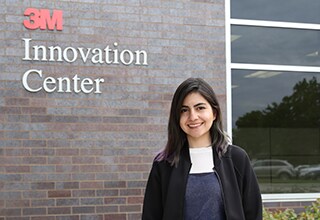Lys Quintero stands next to the 3M Innovation Center