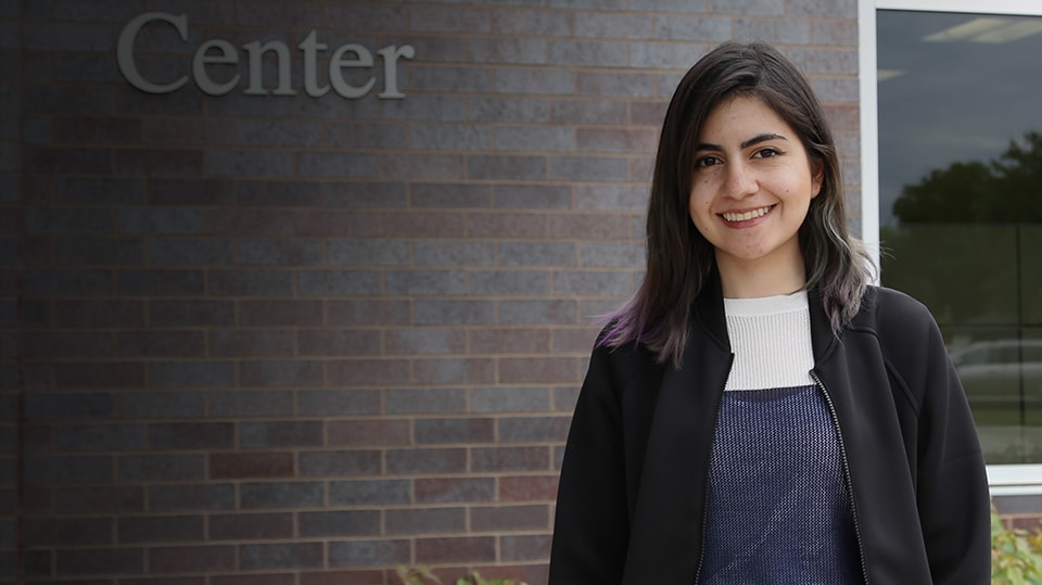 Lys Quintero stands next to the 3M Innovation Center